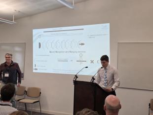 Thomas presenting his work at EIMR Thomas presenting behind a lecturn